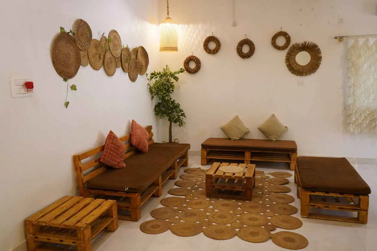 Pallet furniture lounge at Virama Farm Stay near Bangalore — indoor relaxation area