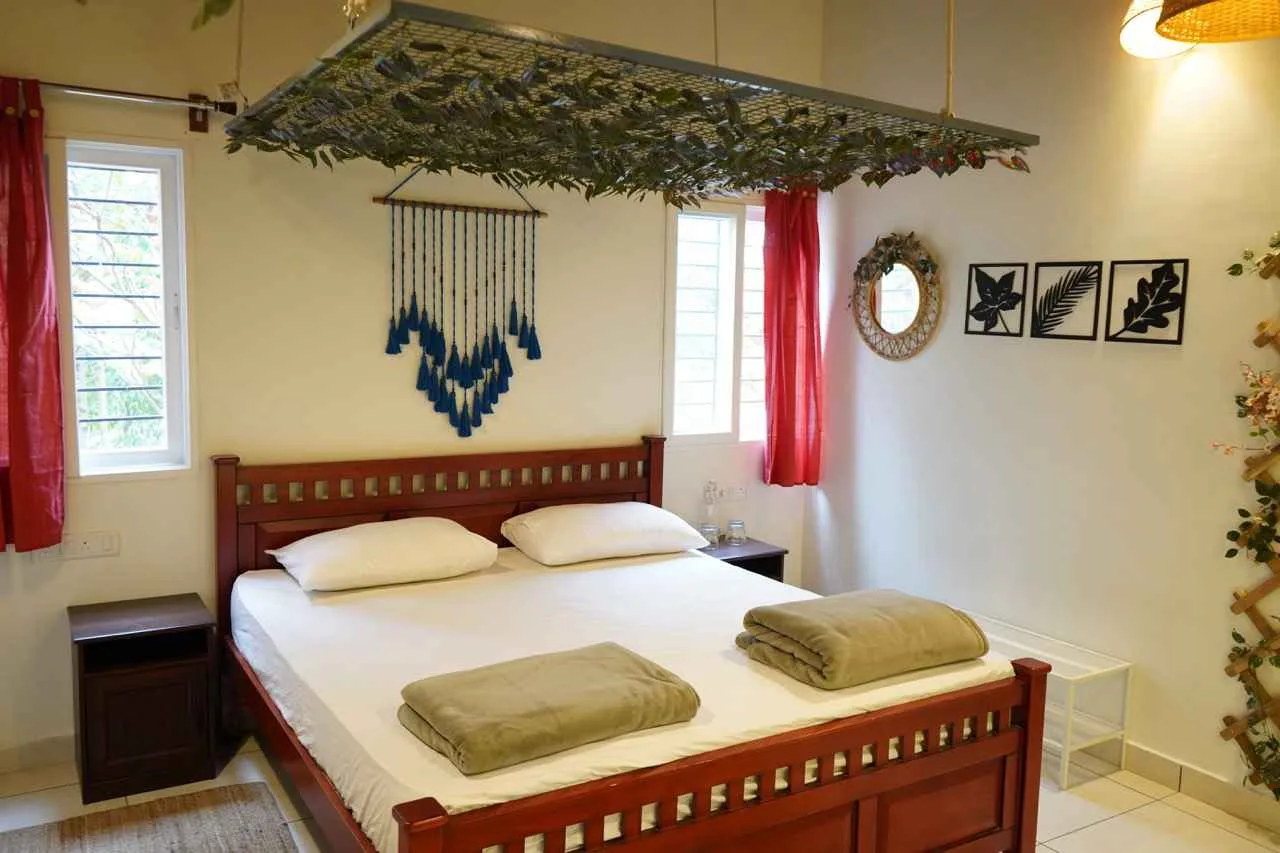 King room with blue macramé decor at Virama Farm Stay near Bangalore
