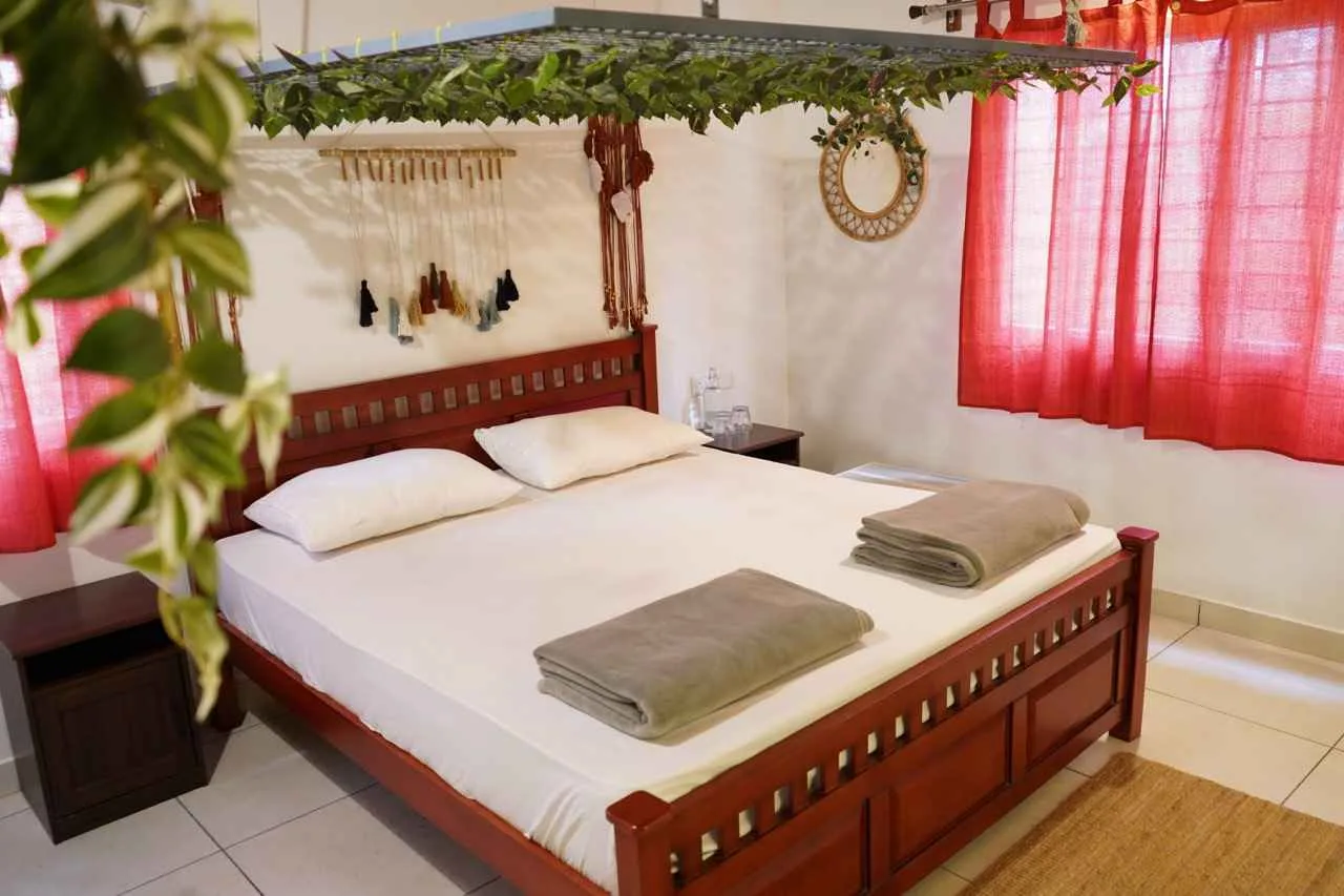 King room with red curtains and vine canopy at Virama Farm Stay near Bangalore