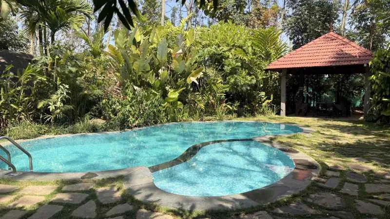 Poolside wooden gazebo at Virama Farm Stay, Magadi Taluk Karnataka — farm stay near Bangalore